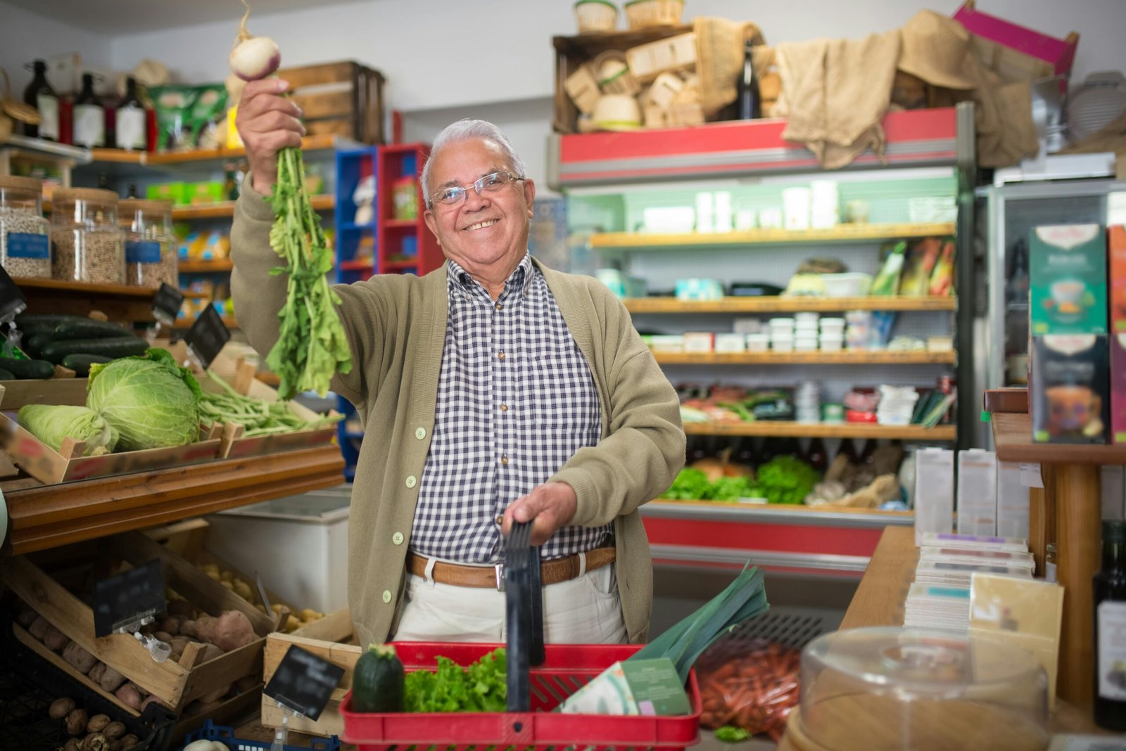 Elderly man joyfully buying fresh produce at a local grocery store.